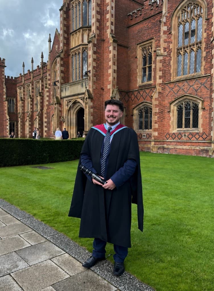 Ryan Davidson in graduation gown outside Queen's University Belfast